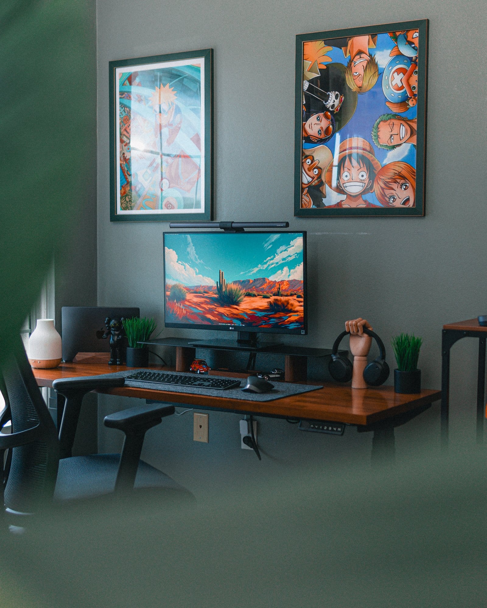 A modern desk setup featuring an LG 27" 27BN88U-B Ergo monitor, BenQ Halo LightBar, 14" M3 MacBook Pro, Edifier W820NB headphones, Edifier R1700BTS speakers, a Satechi Slim X3 keyboard, Logitech MX Master 2S mouse, and a Hexcal desk mat, complemented by anime posters of Naruto and One Piece on the wall