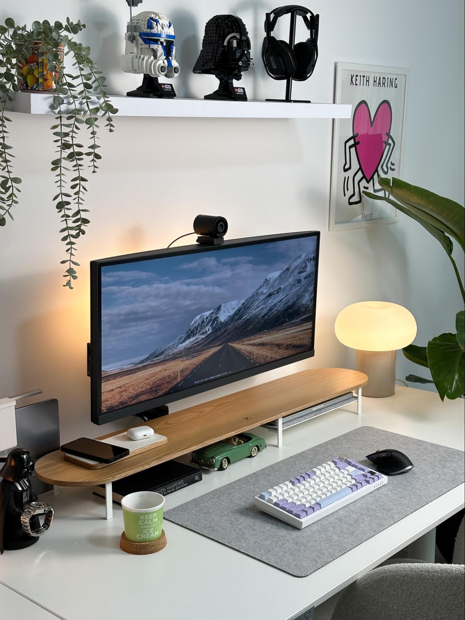 A home office setup with a BenQ PD3420Q UltraWide monitor mounted on a Huanuo Monitor Mount, an EPOMaker Ajazz AK820 keyboard, a Woodcessories desk shelf, and LEGO Star Wars Darth Vader and Captain Rex helmets on a shelf above