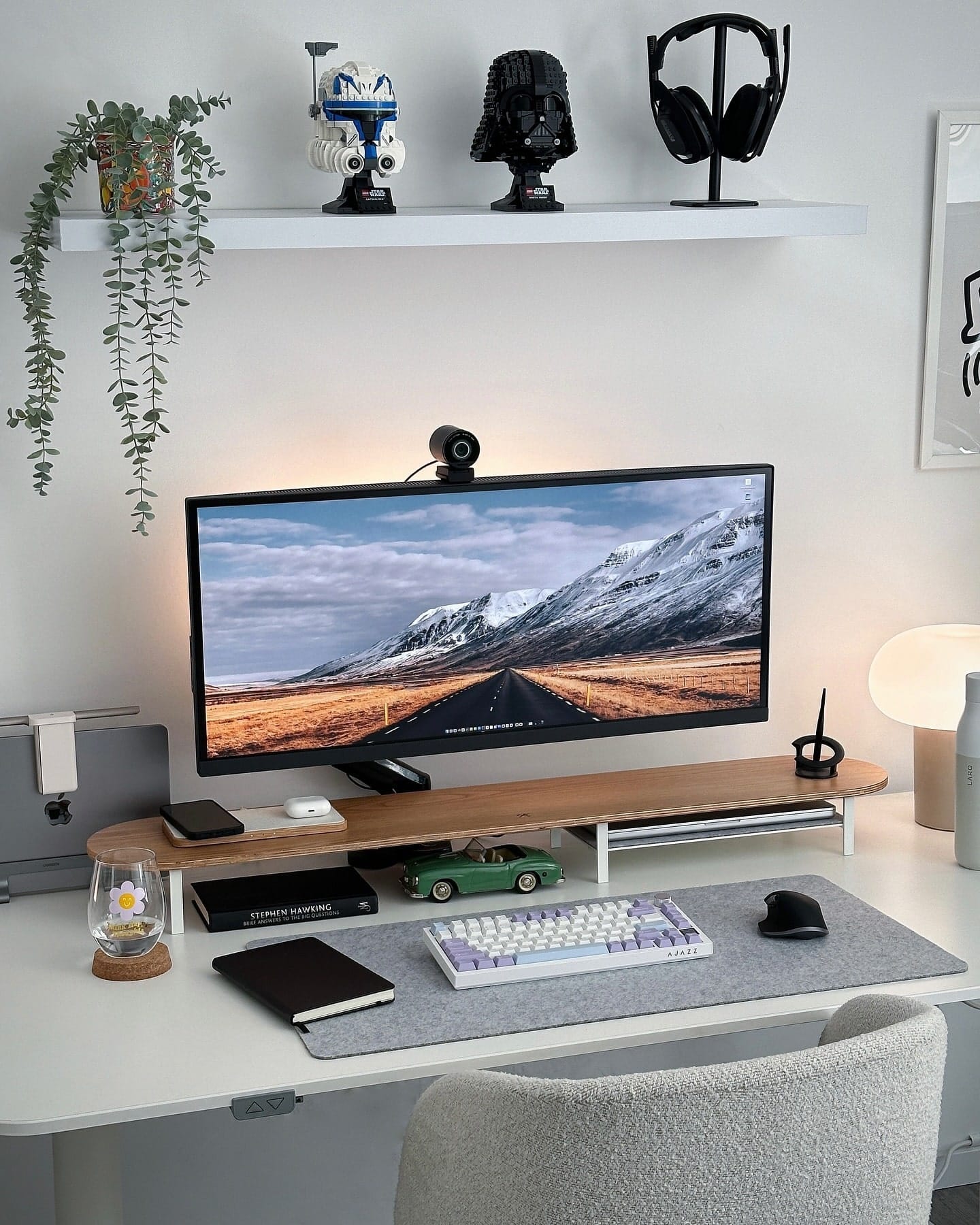 A home workspace featuring a BenQ PD3420Q UltraWide monitor with an EMEET webcam, an Epomaker Ajazz AK820 keyboard, a Logitech MX Master 3S mouse on a felt mat, a Woodcessories desk shelf, and LEGO Star Wars Darth Vader and Captain Rex helmets on a shelf above