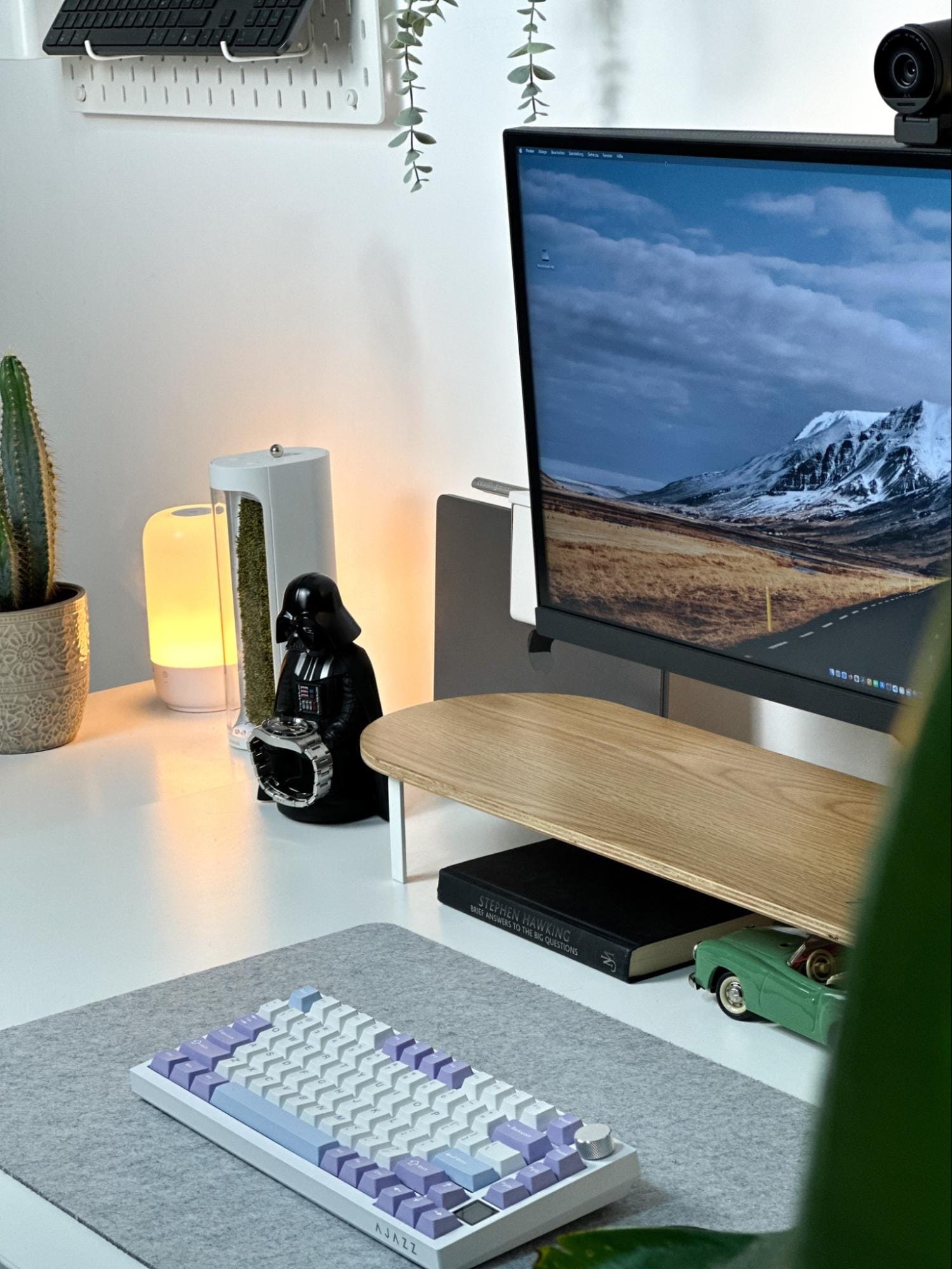 A workspace with a BenQ PD3420Q UltraWide monitor, an Epomaker Ajazz AK820 keyboard on a felt mat, a Woodcessories desk shelf, a mosslab Moss Air purifier, and a Star Wars: Darth Vader Gaming Controller Holder