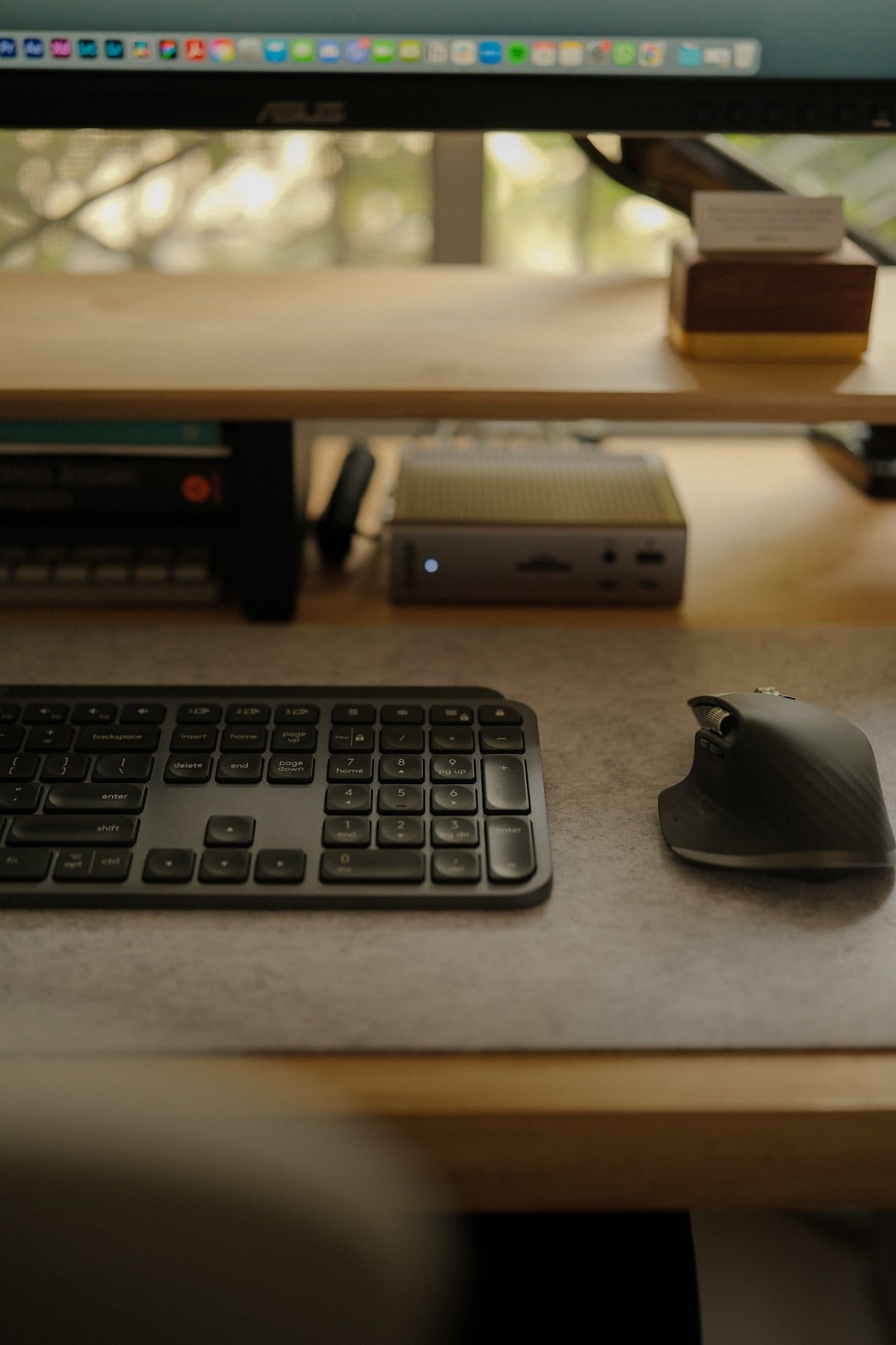 A close-up of a Logitech MX Keys keyboard and a Logitech MX Master 3S mouse on a felt desk mat, with a CalDigit TS4 Thunderbolt Dock placed beneath an ASUS ProArt PA278QV monitor
