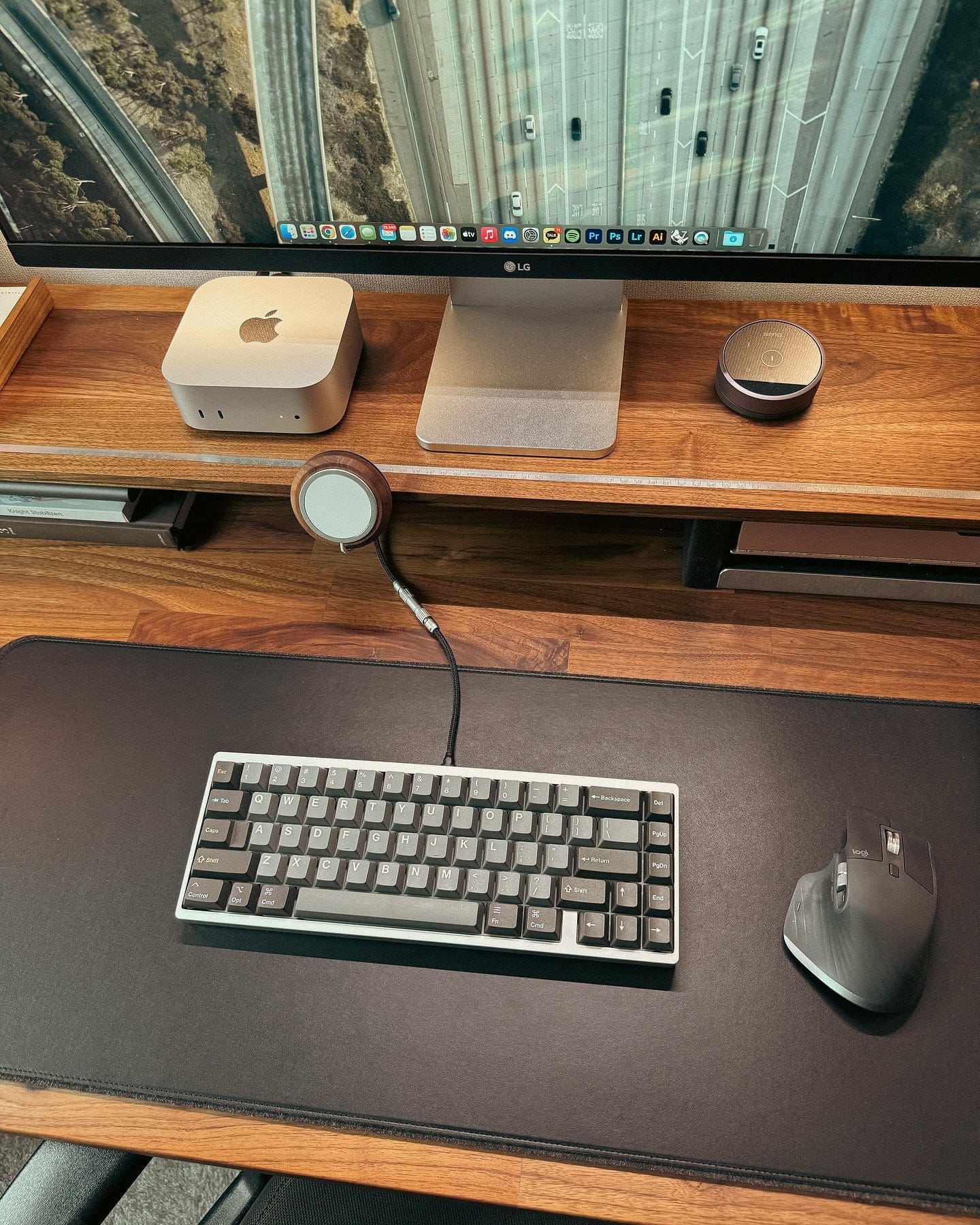 A desk setup with a Mac Mini M4, LG monitor, and Logitech MX Master 3S mouse