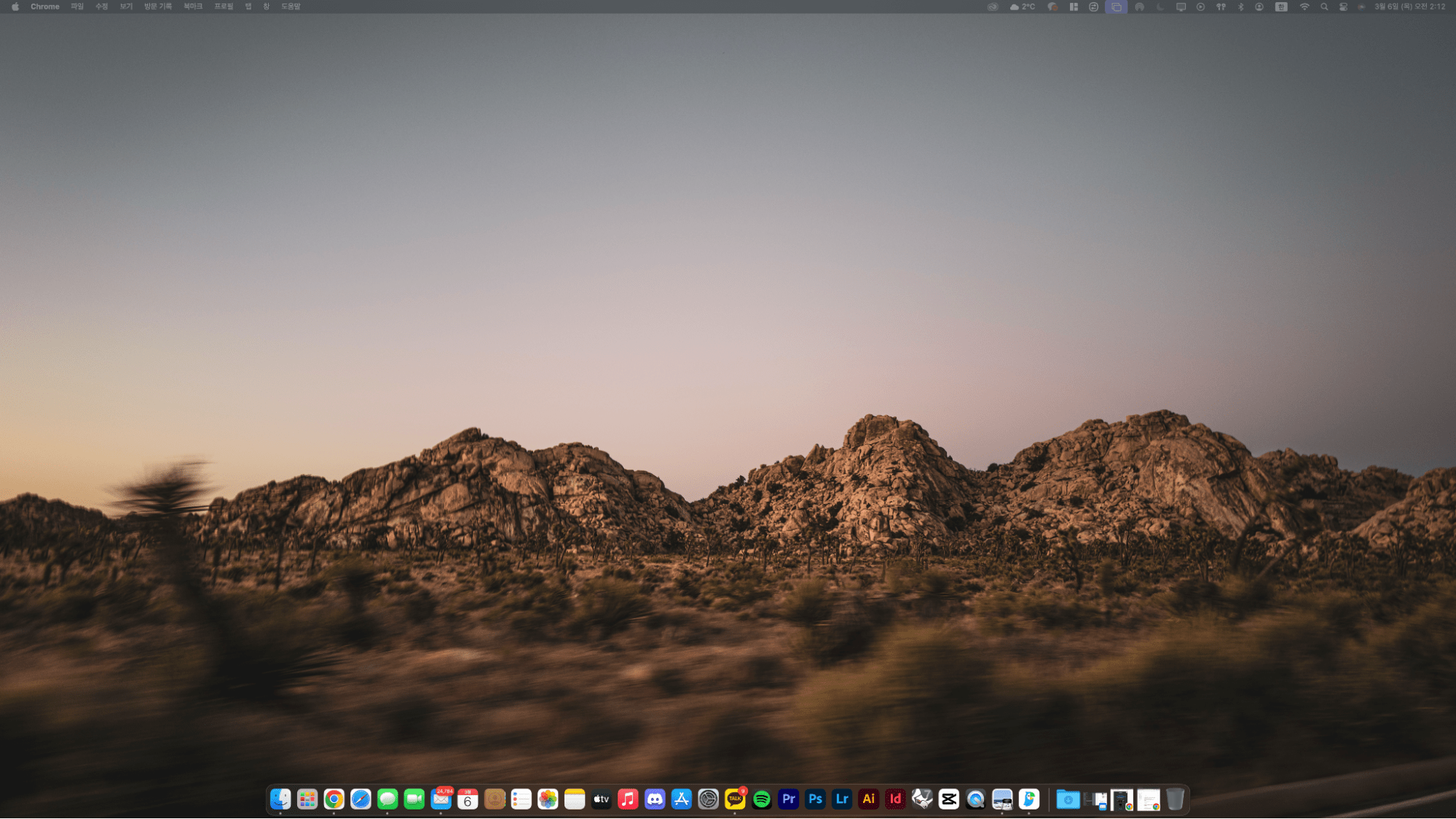 A Mac desktop screen with a sunset mountain wallpaper and app dock visible