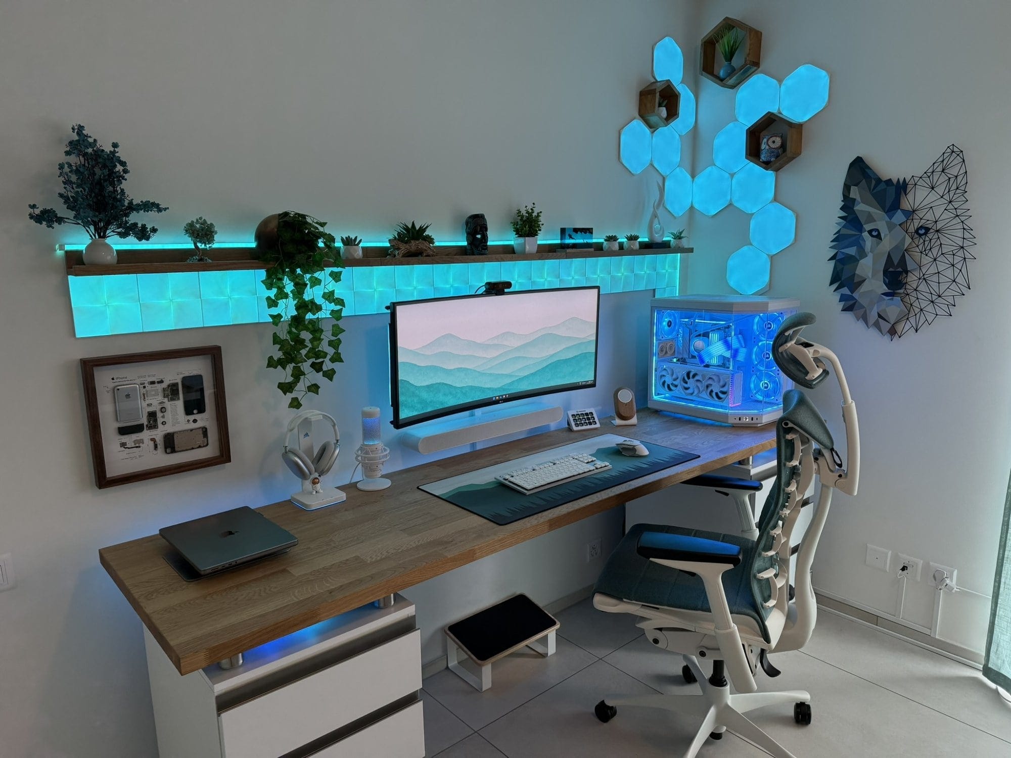 A gaming setup with an LG 38GN950 monitor, Hyte Y70 PC case, Nanoleaf LED panels, and Herman Miller Embody chair