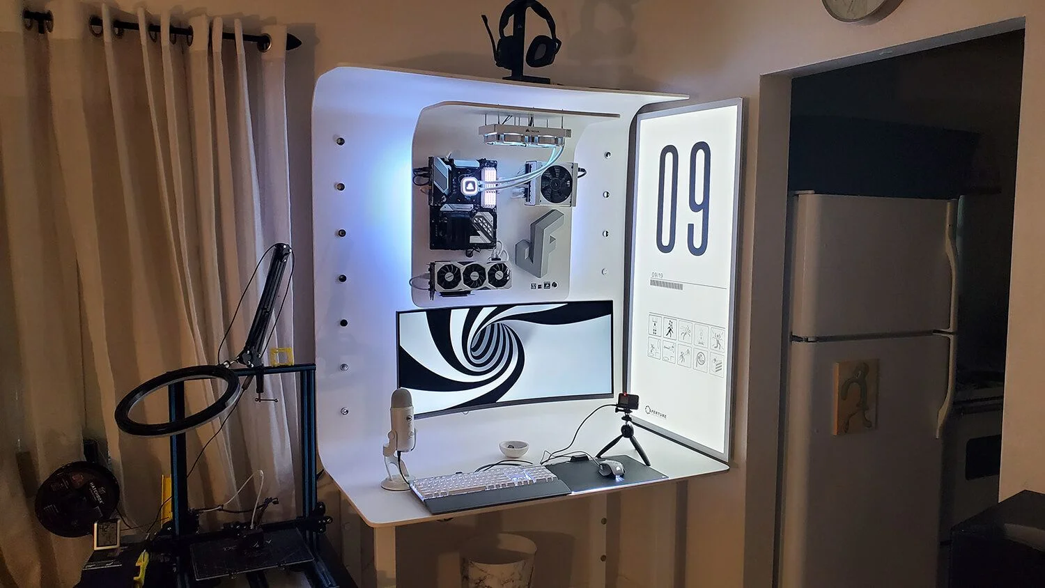 A vertical, capsule-like DIY PVC workspace with a custom-mounted computer and sci-fi styled interface