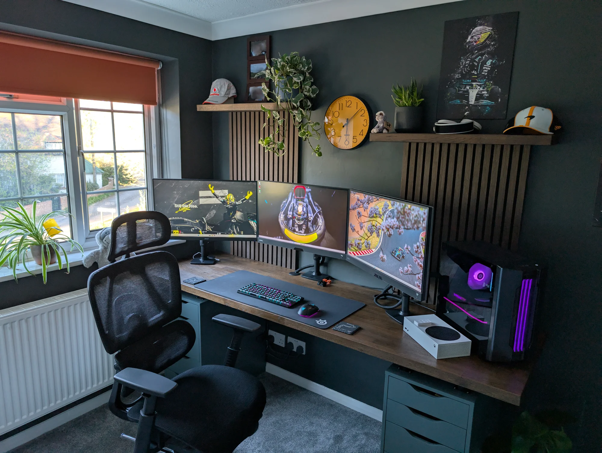 A home office setup with 3 monitors (2× BenQ EX2710Q, 1× Acer), Razer Deathstalker V2 Pro keyboard, and Xbox Series S on a wood desk with IKEA ALEX drawers