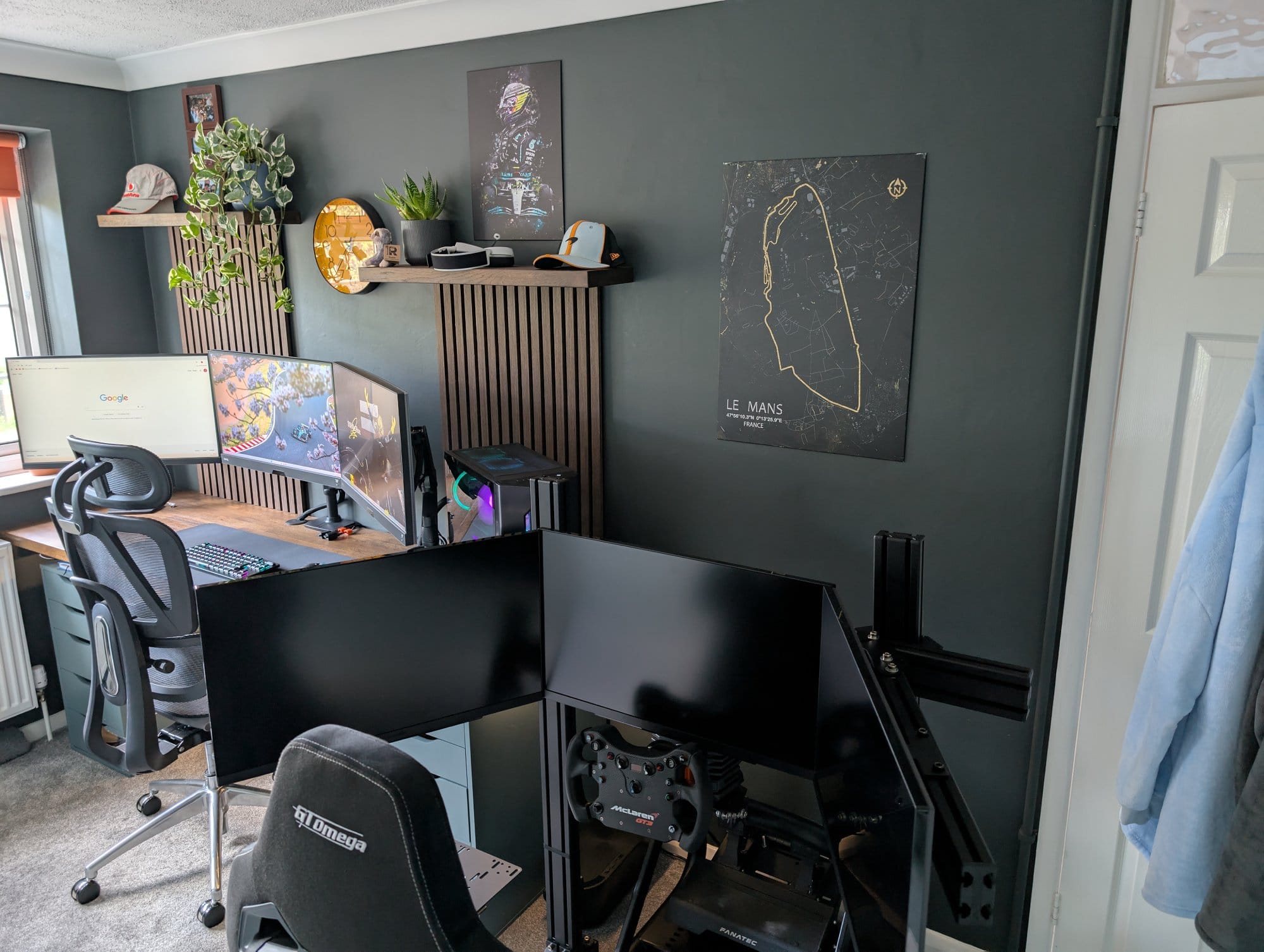 A hybrid workspace with a GT Omega sim rig, Fanatec CSL Elite wheel, and triple-monitor desk setup