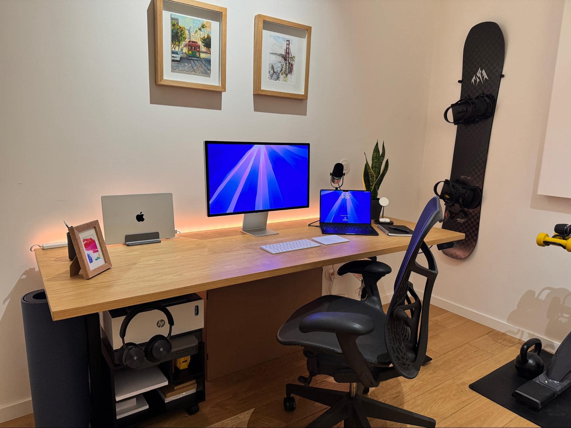 A home office with an Apple Studio Display, a MacBook Air M4, and a Herman Miller Aeron chair