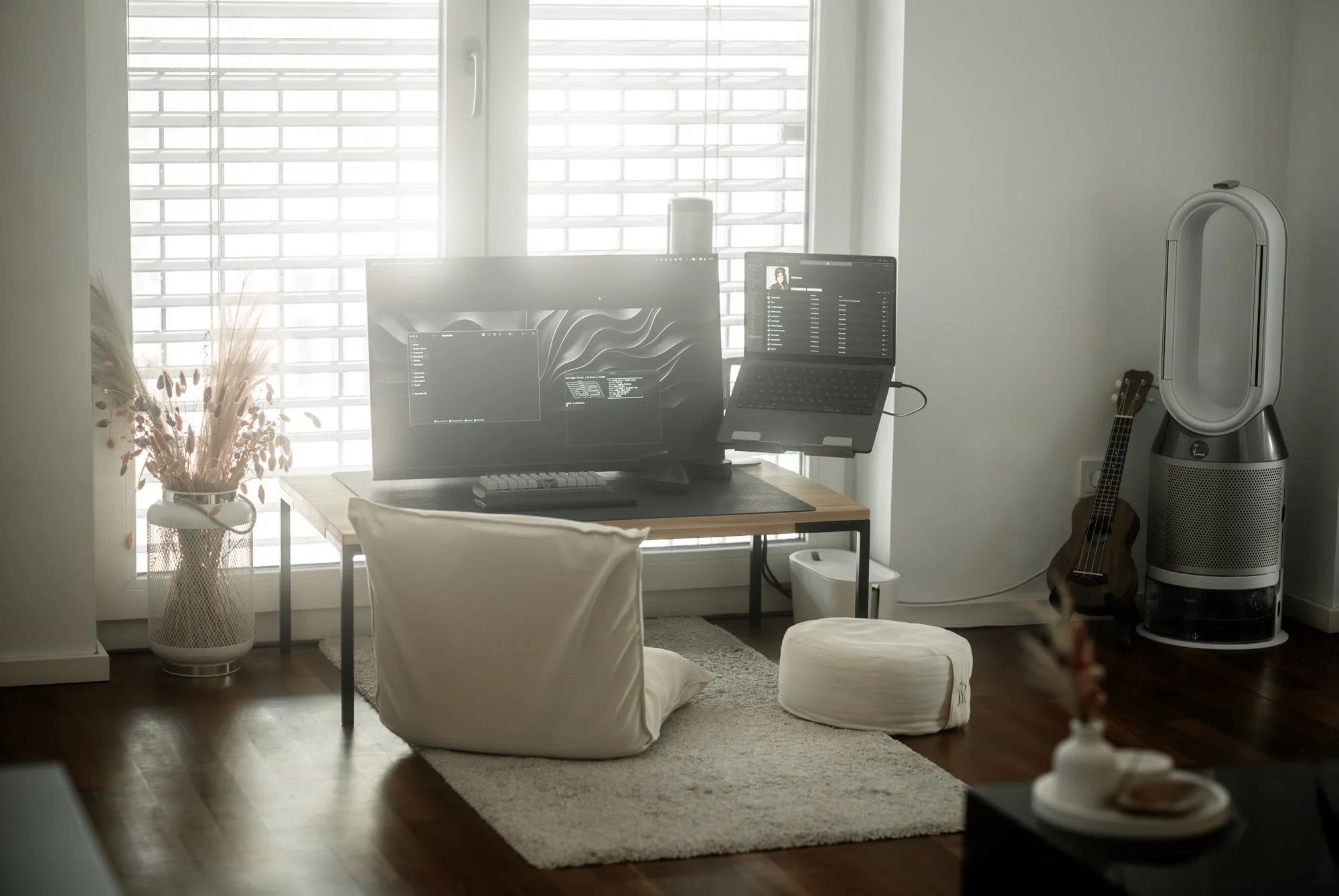 A floor desk setup with Acer Nitro, MacBook Pro, and OLKB Planck keyboard