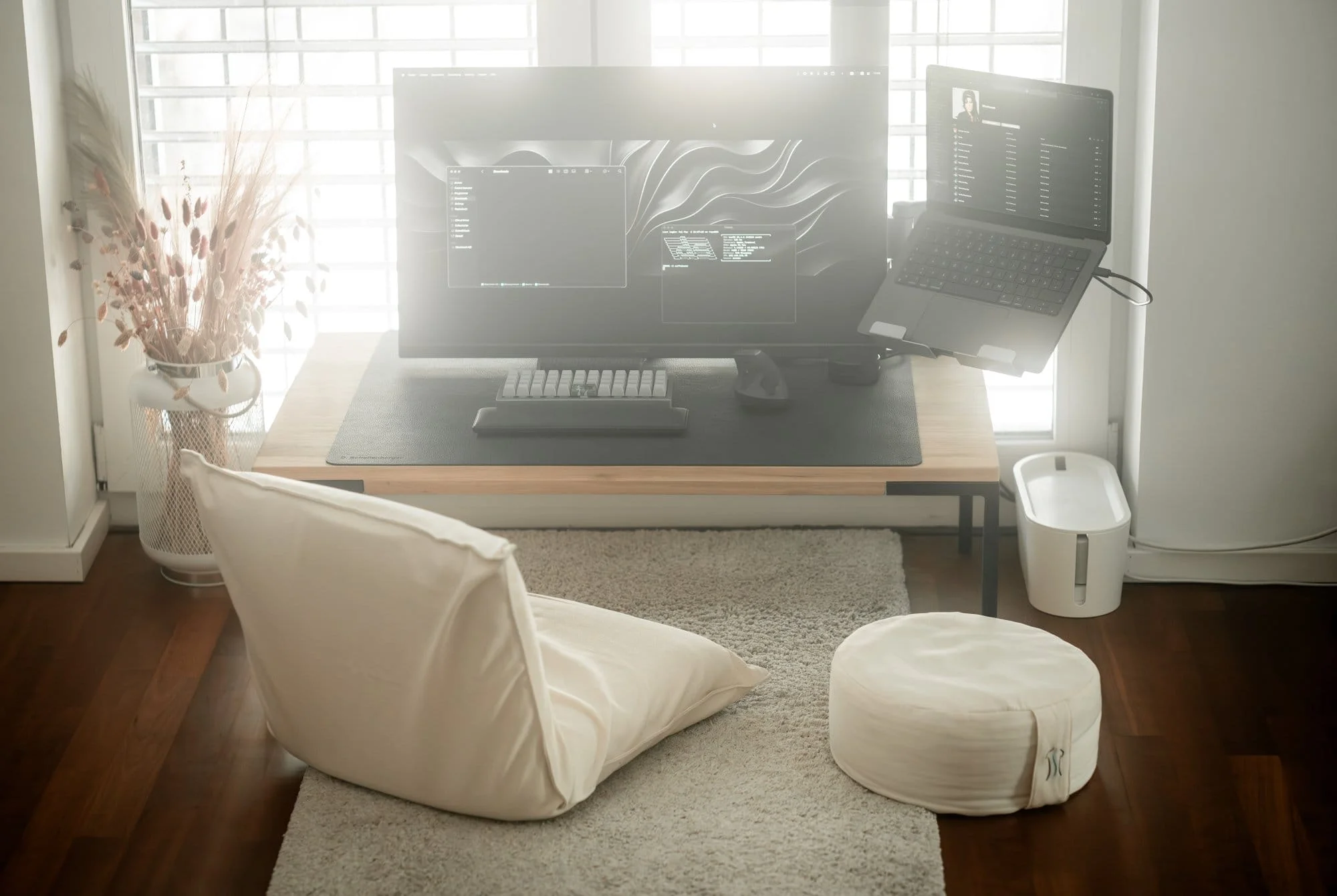 A Japandi-style setup with a MUJI floor chair, Acer monitor and Apple MacBook laptop