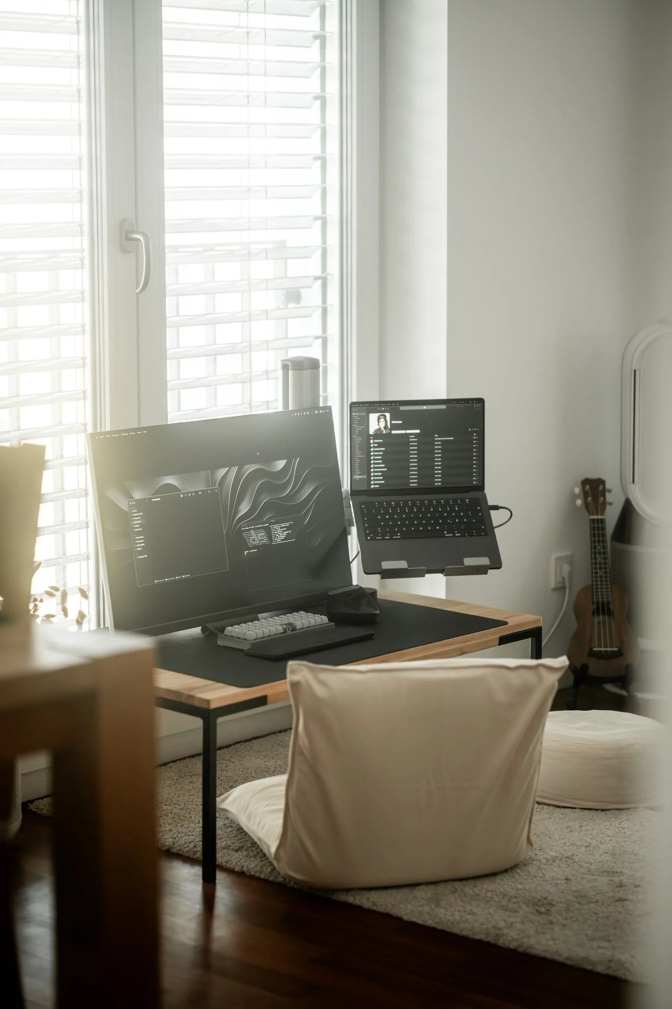A floor desk setup with a MUJI chair, yoga pillow, Acer Nitro, Planck keyboard, and MX Vertical