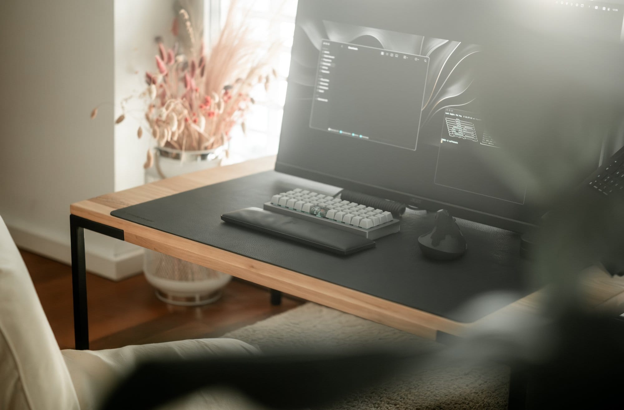 A wooden desk with Acer Nitro monitor and OLKB Planck keyboard