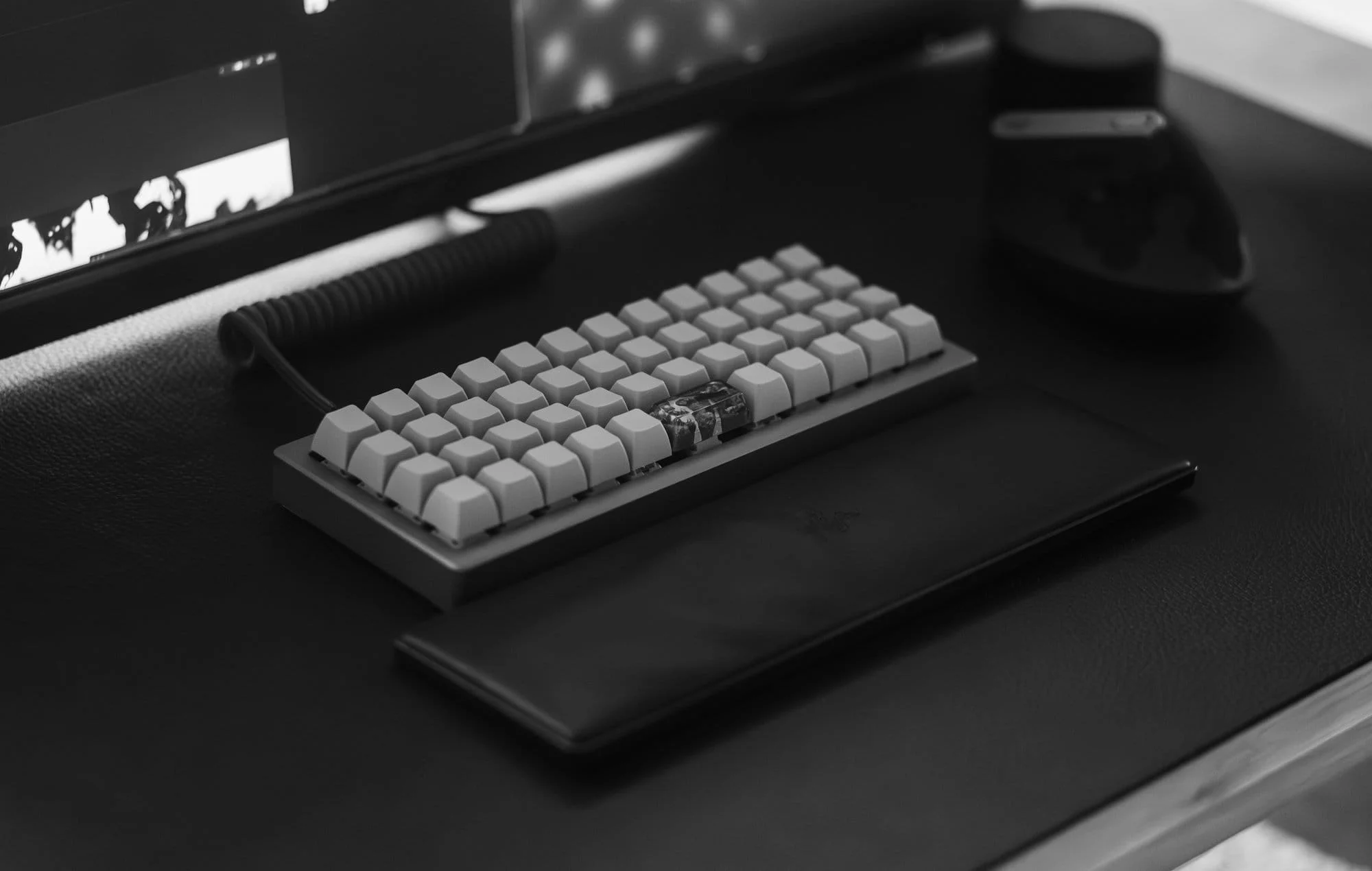 A close-up of OLKB Planck keyboard and Razer wrist rest