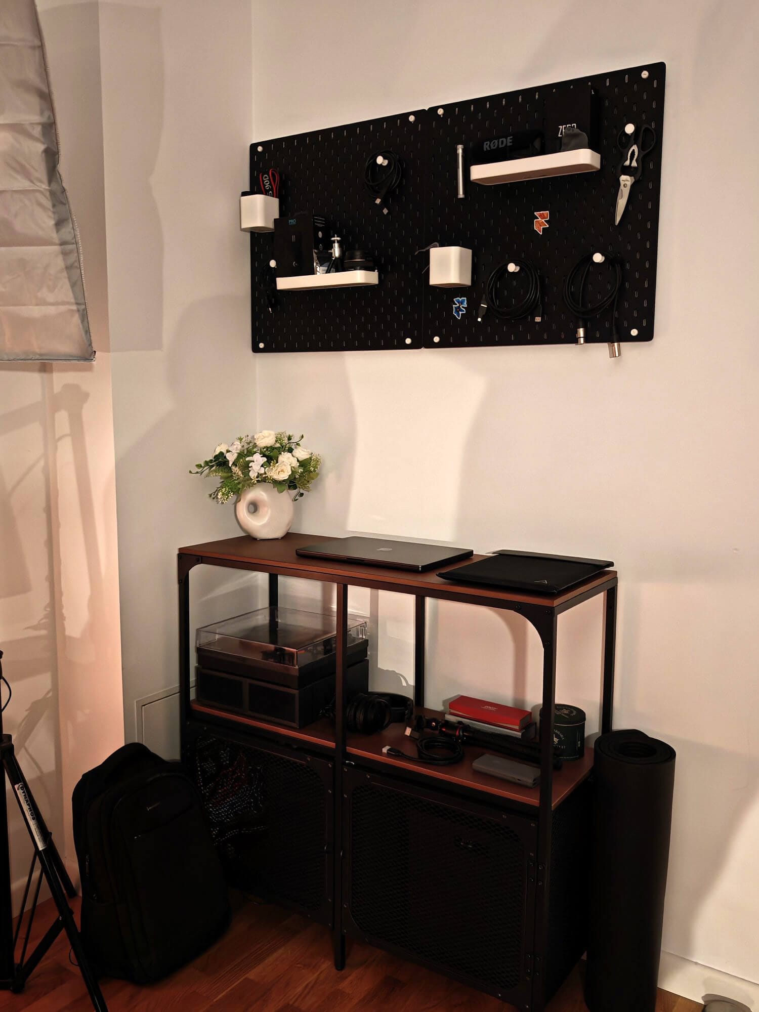 A shelf with MacBook Pro M4 Max, Scarlett 2i2 under black pegboards