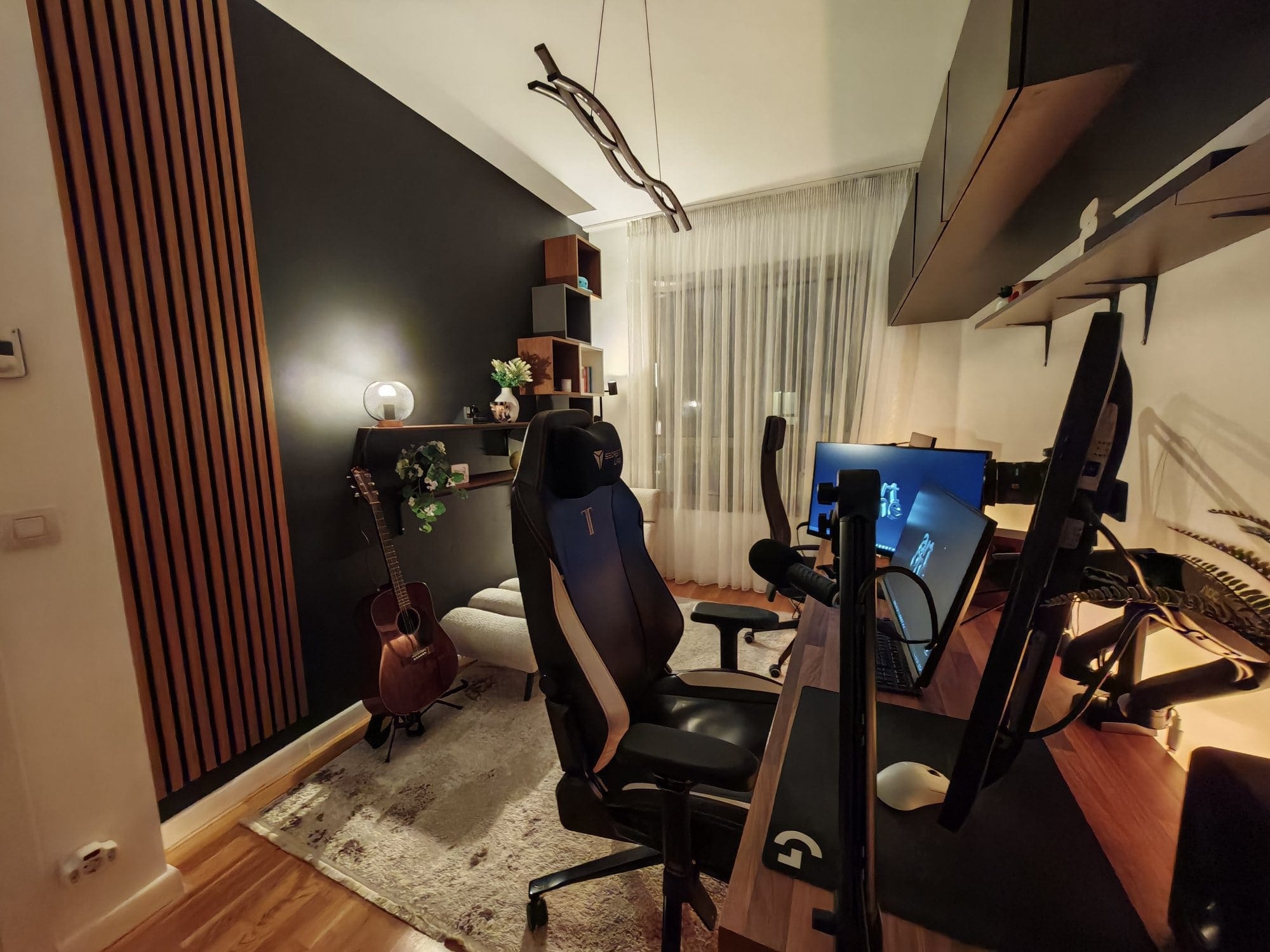 A Secretlab Titan Evo chair beside a Philips 27″ 4K UHD monitor