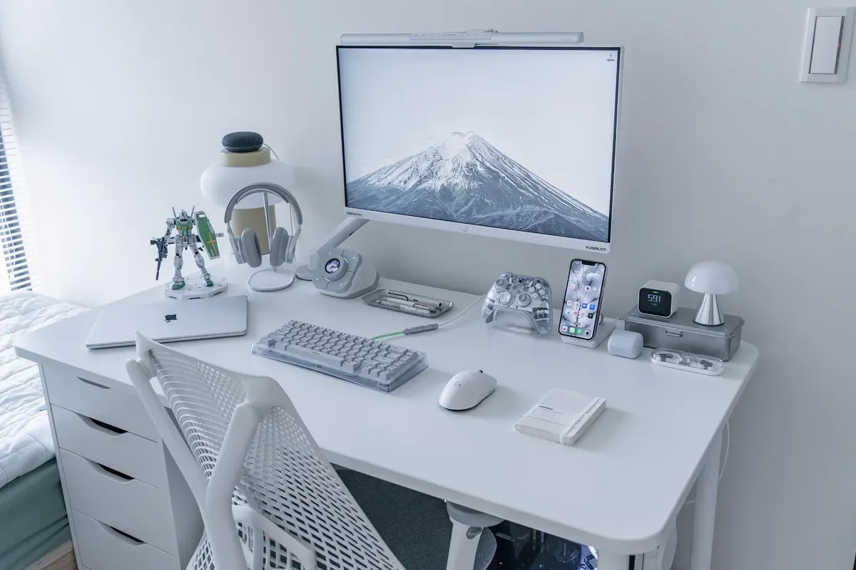 A white and minimal small bedroom desk setup with a Herman Miller Sayl chair