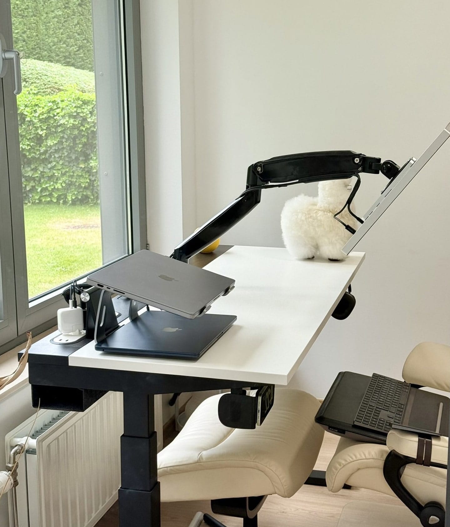 A side view of a zero gravity standing desk setup with a reclining chair