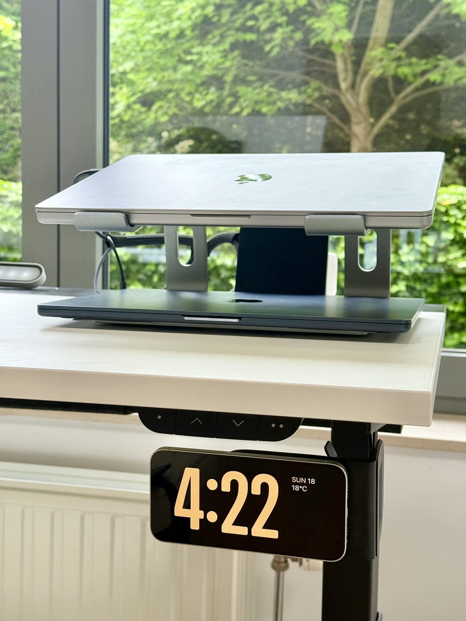 A MacBook Pro 16″ M1 Pro on a Nulaxy stand atop an IKEA MITTZON desk with a digital clock display showing 4:22