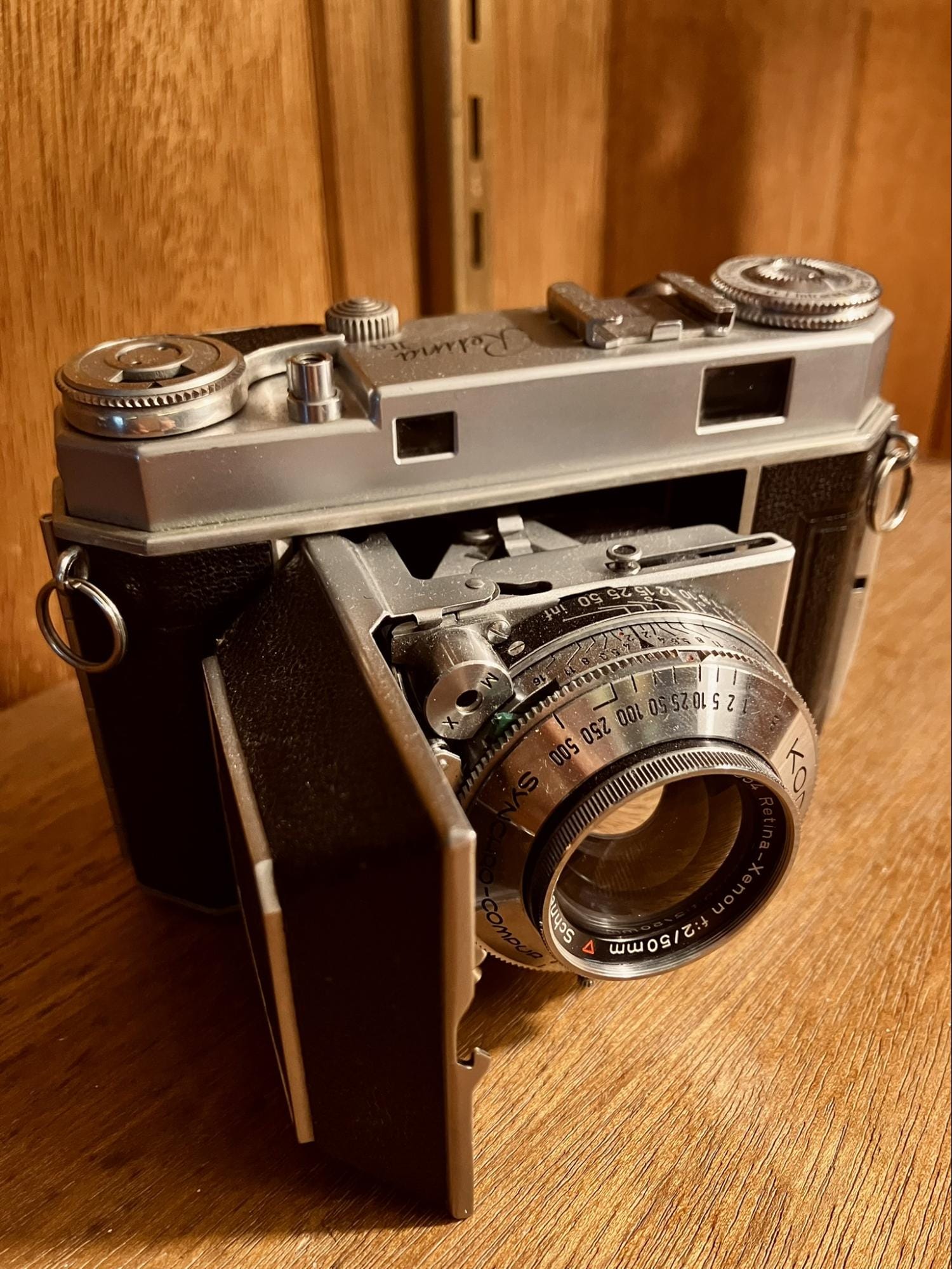 vintage Kodak Retina IIa film camera with folding lens displayed on wooden surface