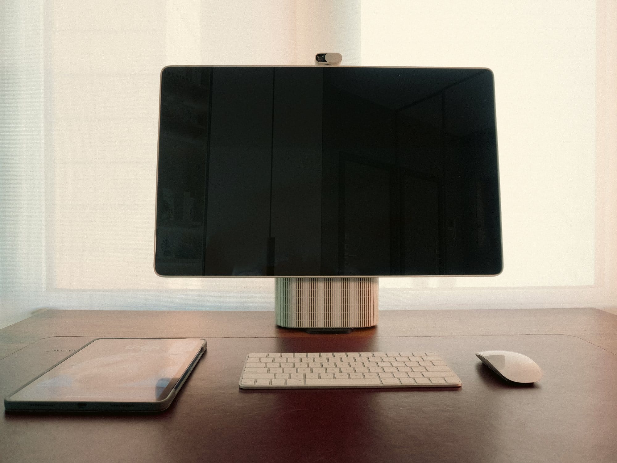 the HomeTechCo Home Display on a desk with a keyboard, mouse, and tablet