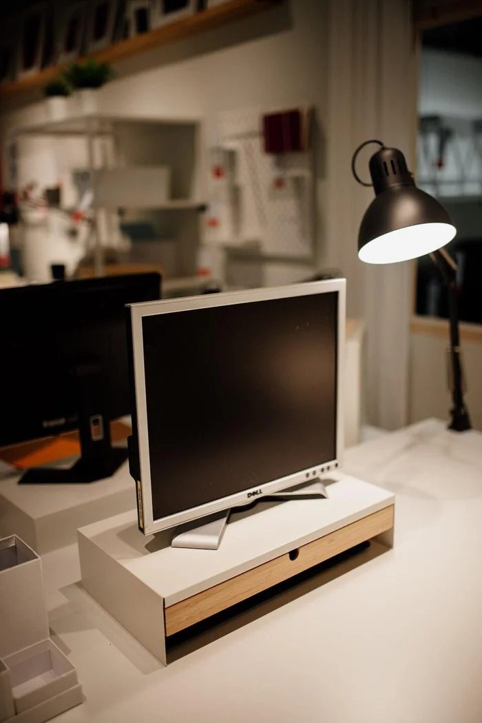Workspace setup with a computer monitor and desk lamp